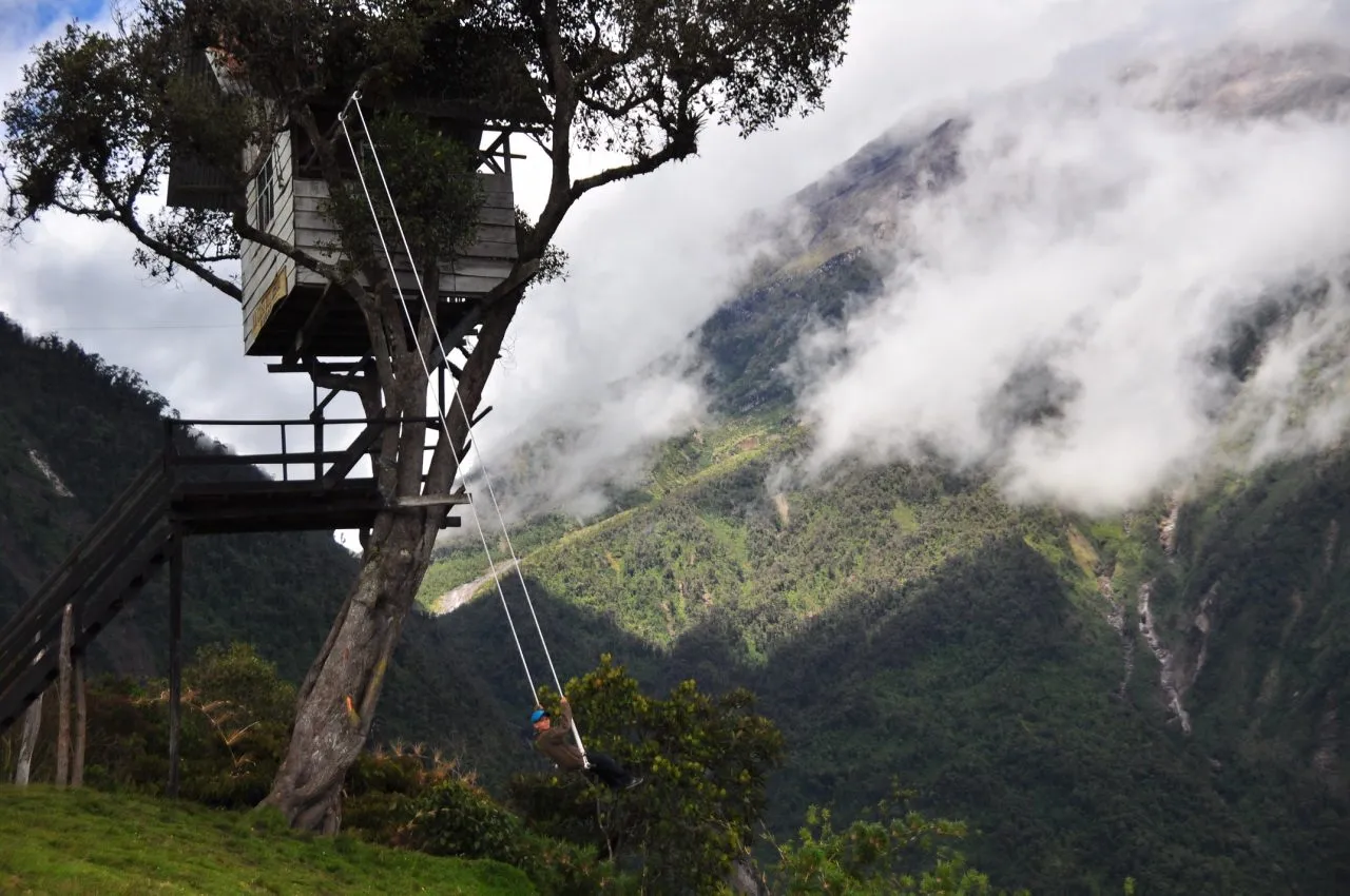 The swing at the Casa del Árbol above Baños, with the valley below