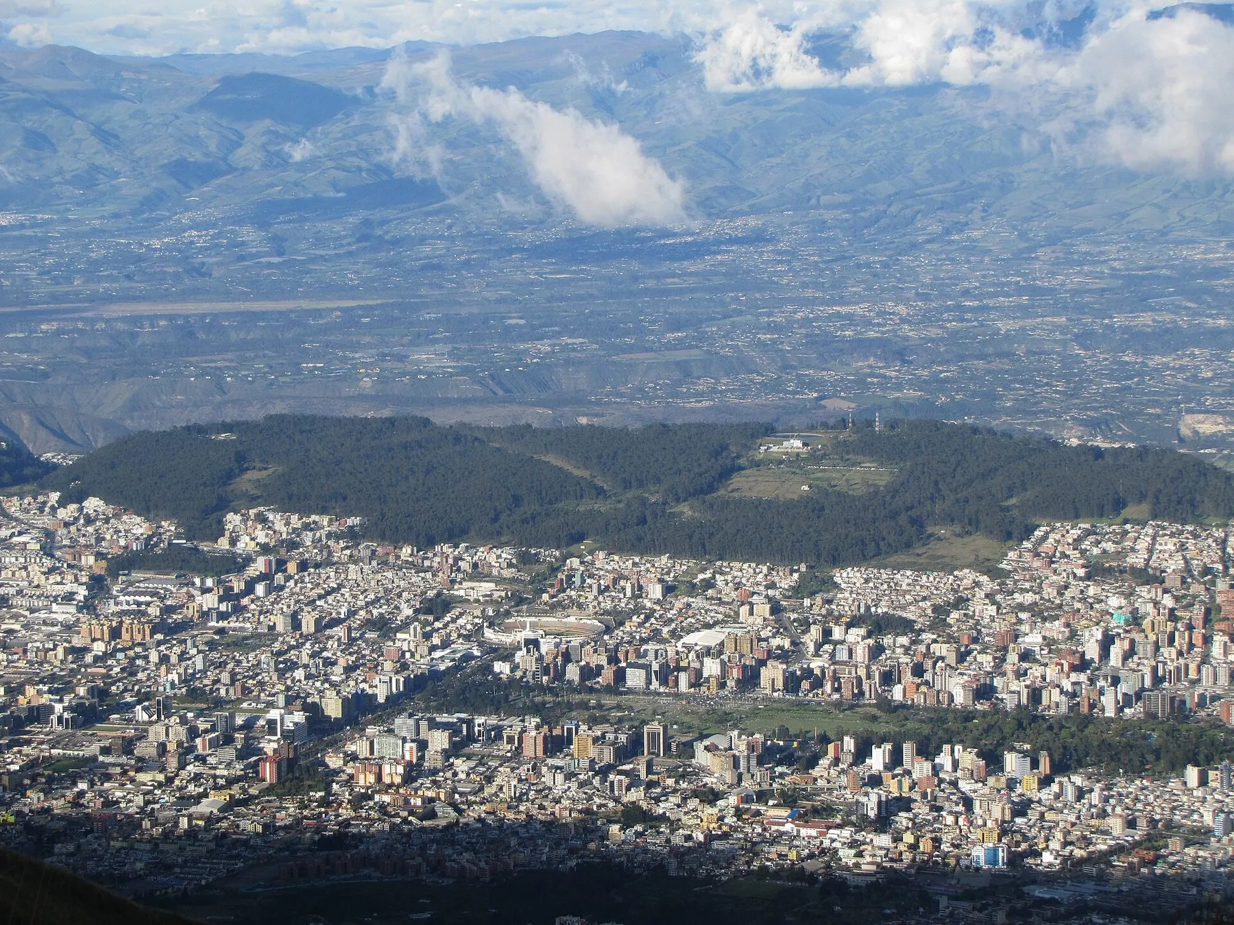 The TelefériQo cable car above Quito, with the city and the volcanoes beyond